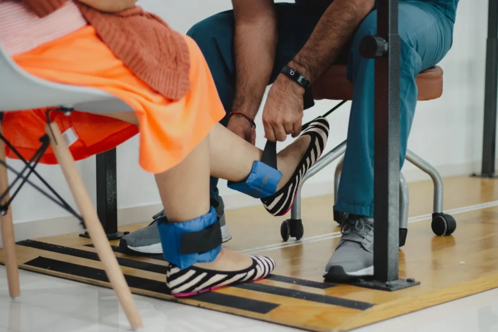 Ankle weights fitted for a seated leg exercise session