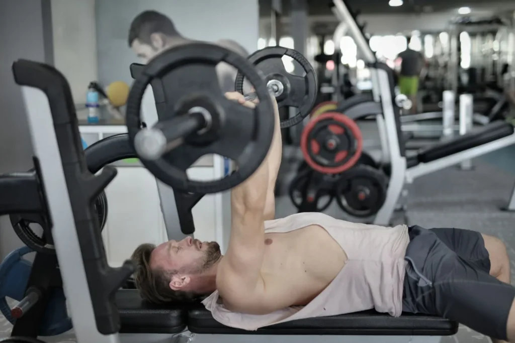 Lifter pressing a barbell on a flat bench