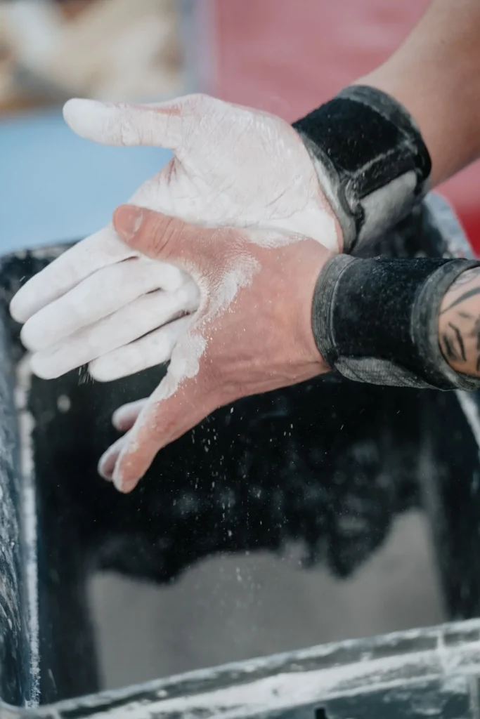 Hands applying chalk before a training session