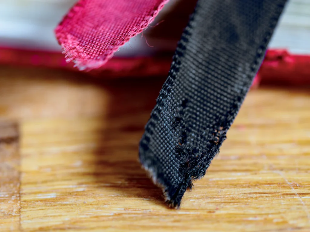 Close-up of the edge of a dark cotton webbing strap