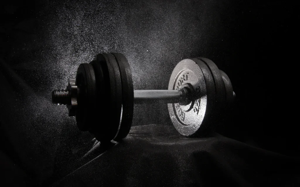 Barbell and weight plates on a dark background