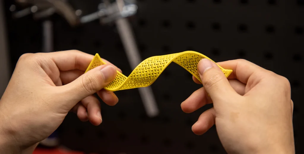 Hands stretching a yellow elastic band