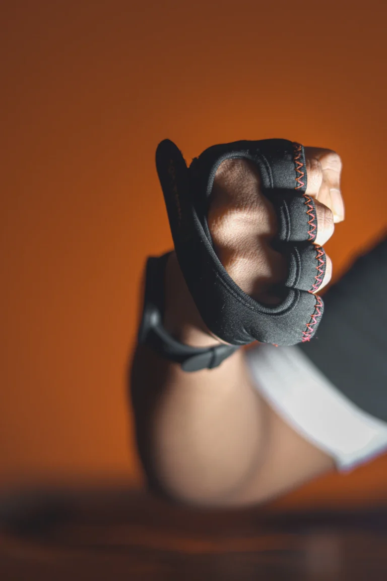Close-up of a hand holding a pair of training gloves