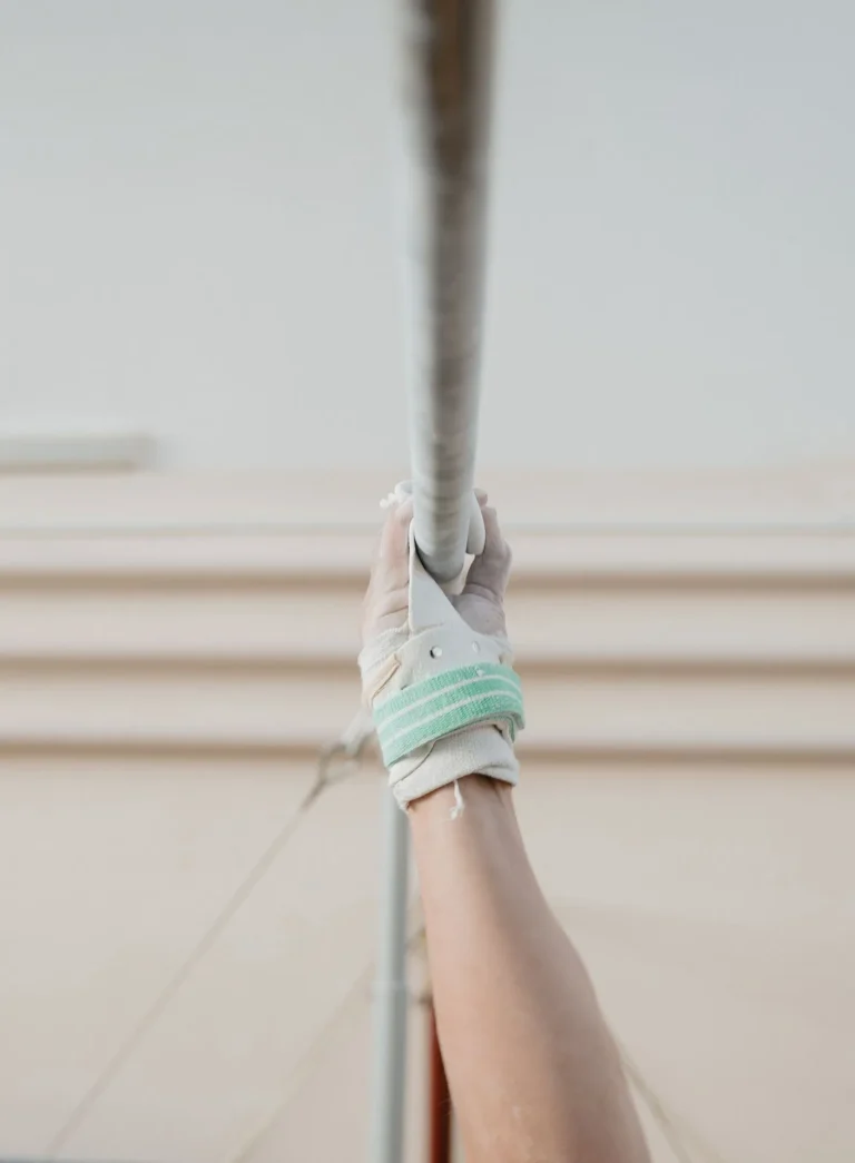 Gymnast's hand in a leather grip on a high bar