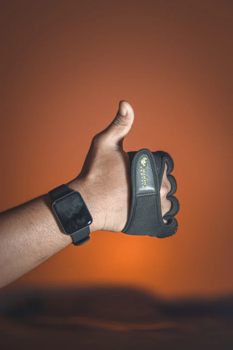 Hand wearing a leather palm grip with wrist strap