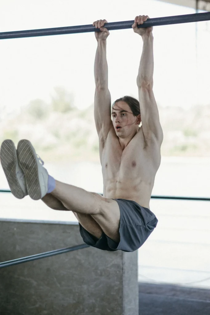 Athlete holding a hanging leg raise on a bar