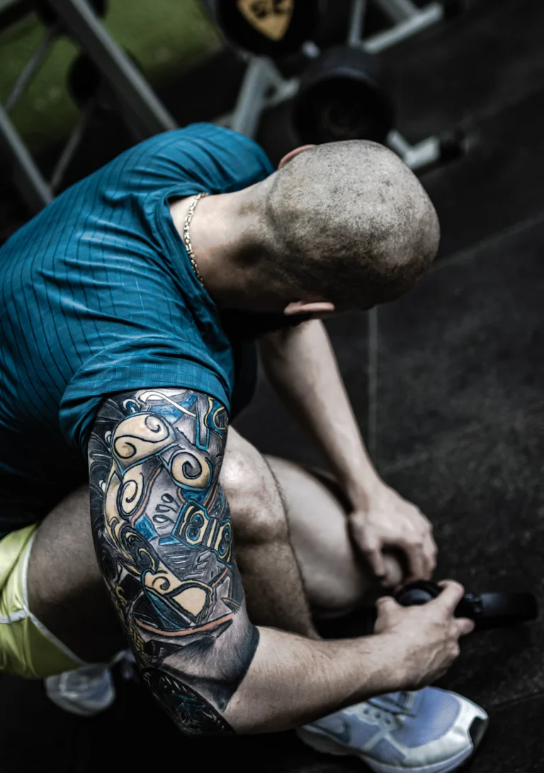Lifter pulling a knee sleeve into place before training