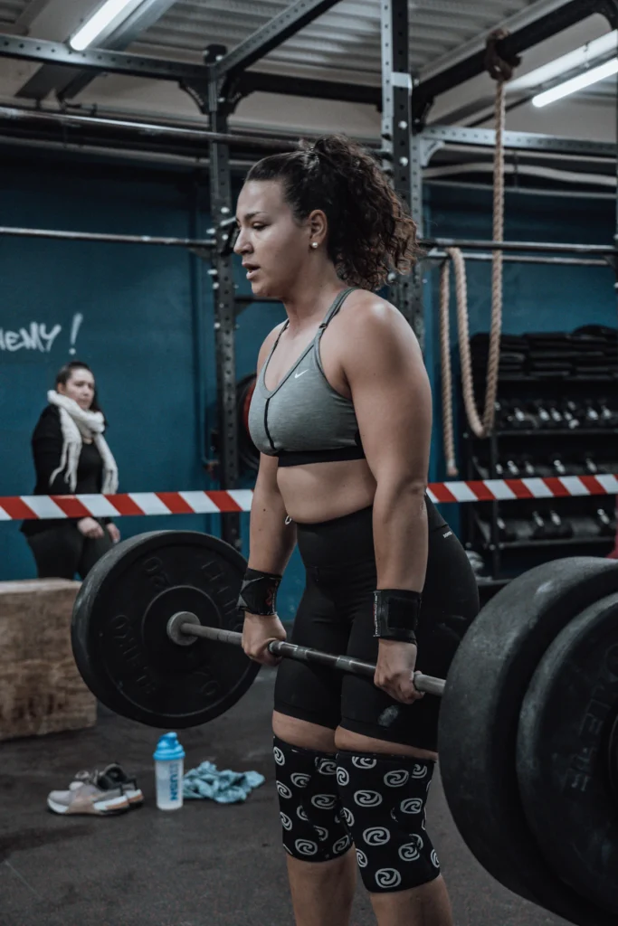 Athlete wearing knee sleeves while lifting a barbell