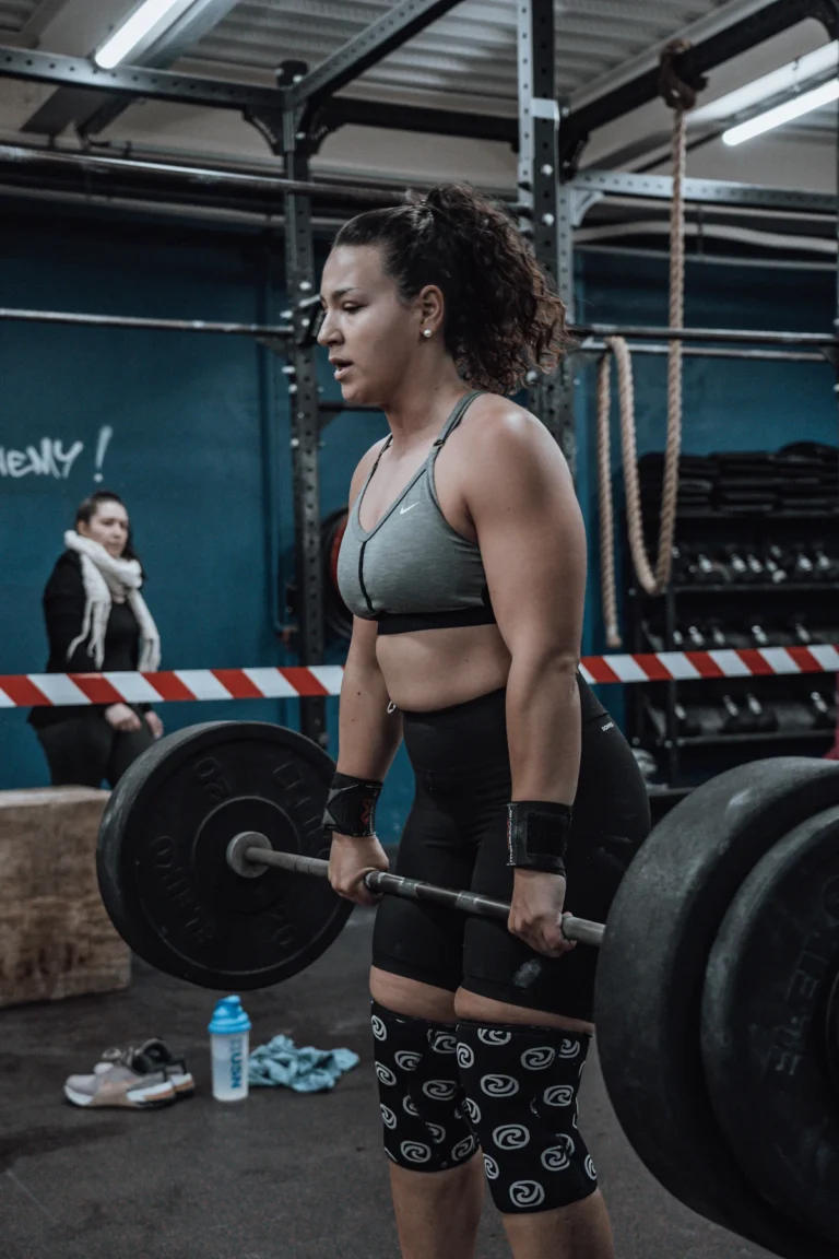 Athlete wearing knee sleeves while lifting a barbell