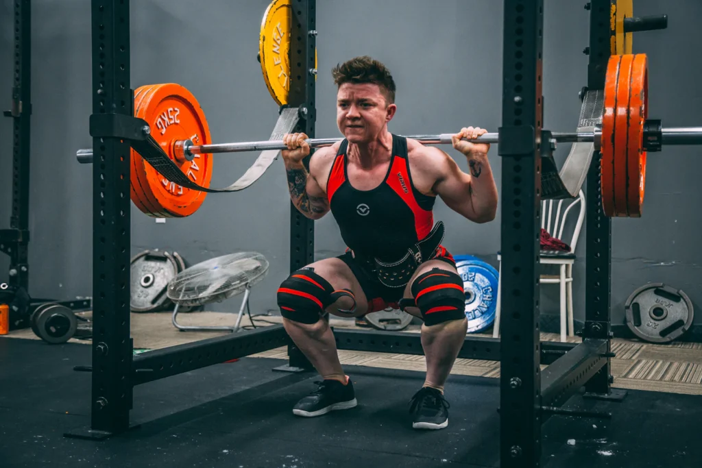 Powerlifter squatting in knee wraps