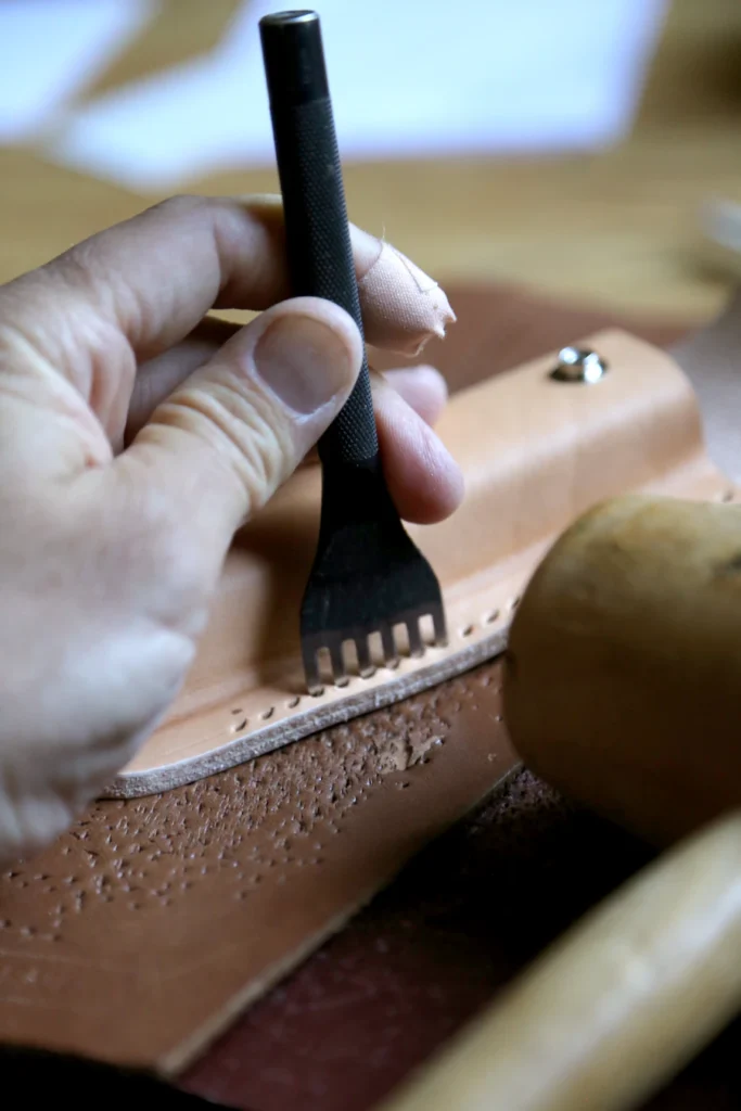 Leather detailing tool used during accessory finishing