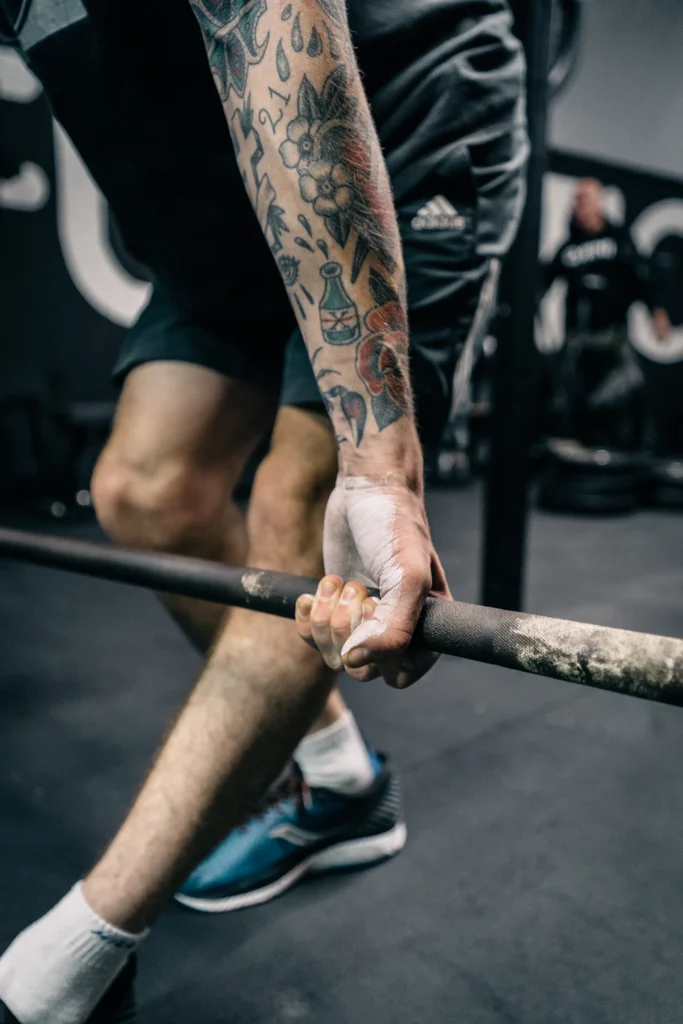Lifting strap wrapped around a barbell during a pull