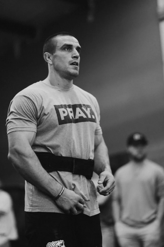 Athlete wearing a black training belt in the gym