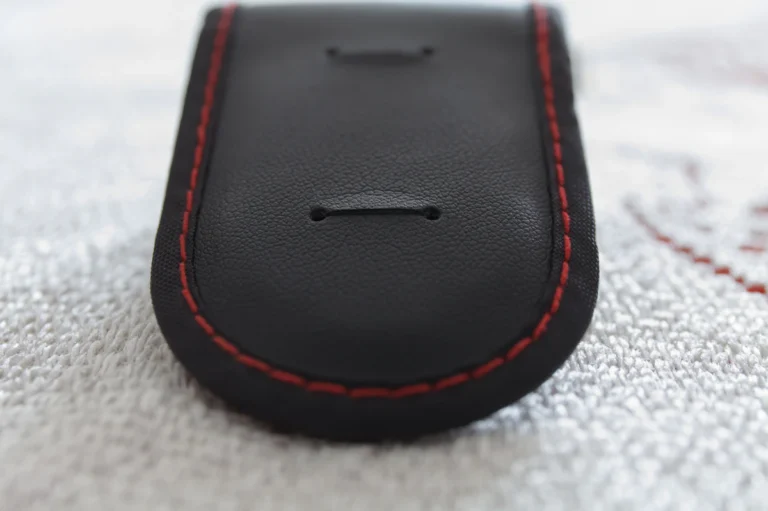 Close-up of even contrast stitching on a black leather accessory