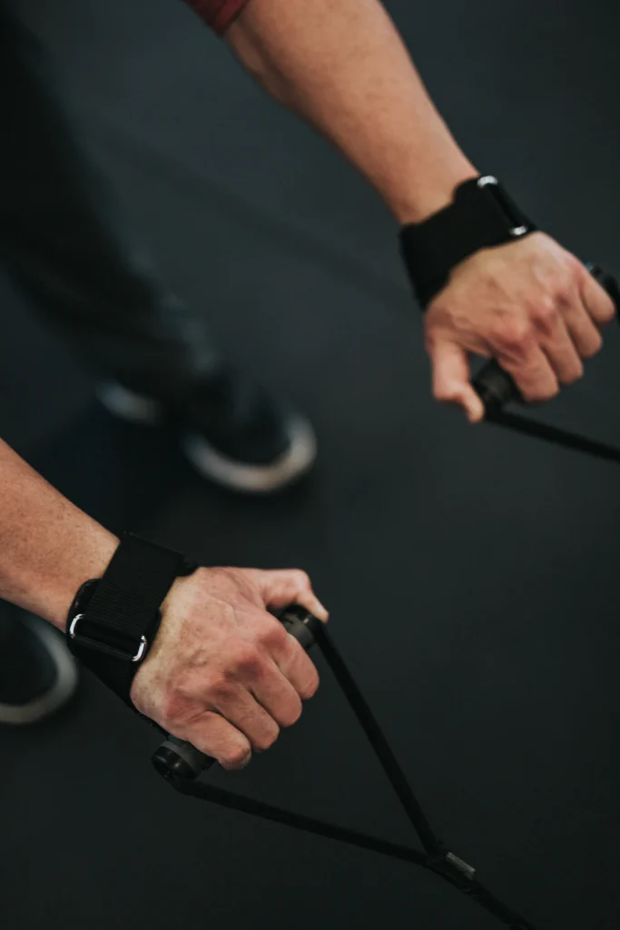 Athlete wearing wrist straps during a cable pull