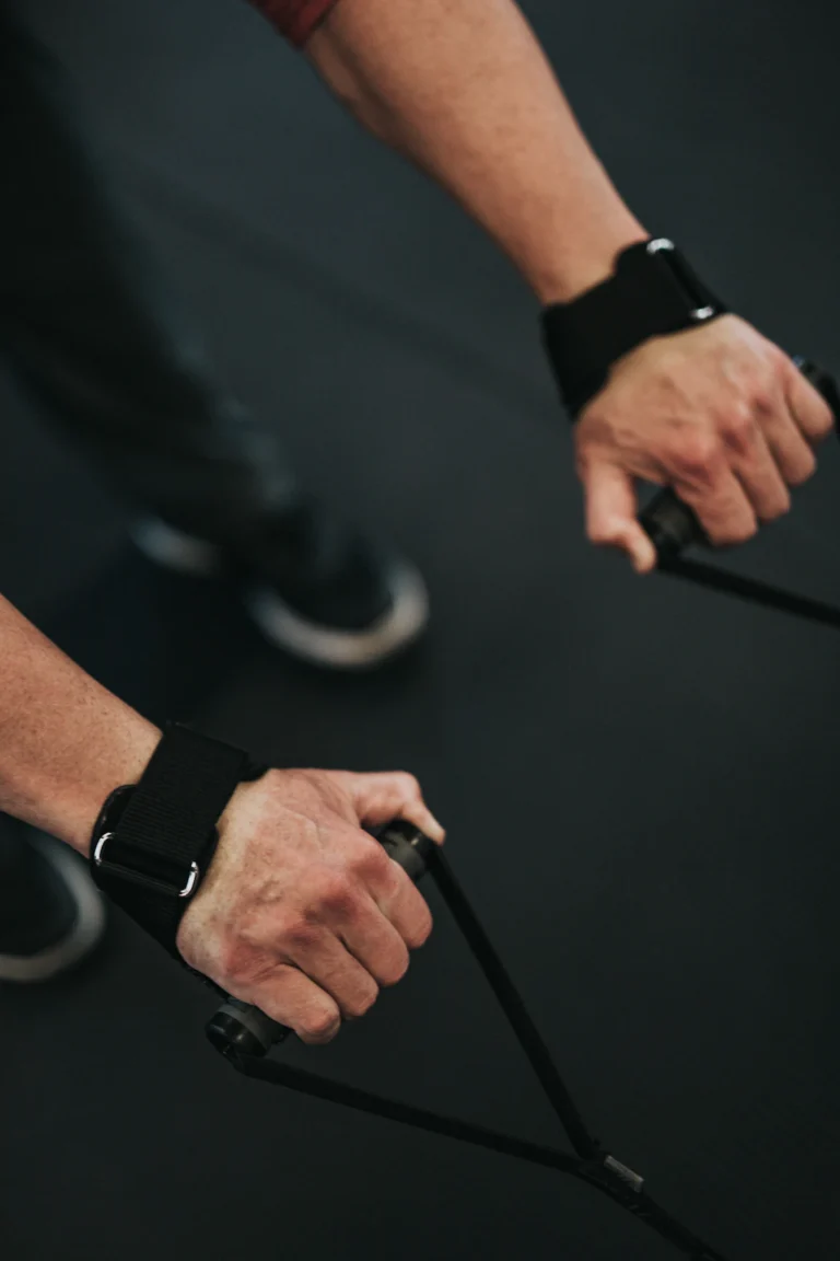 Athlete wearing wrist straps during a cable pull