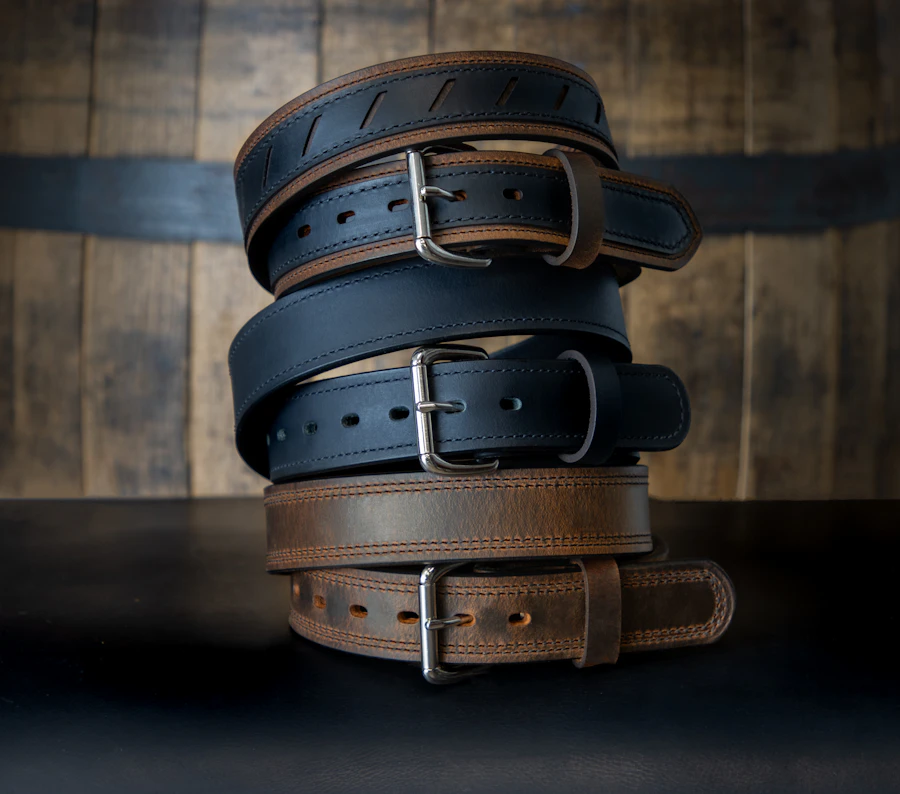 Strength training accessories including bands and a lifting belt hanging on a rack