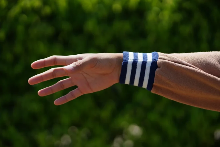 Blue and white striped cotton wrist wrap on an outstretched arm