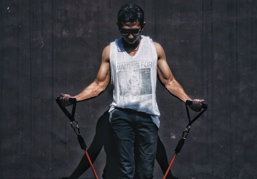 Man using a resistance tube with handles for a chest press