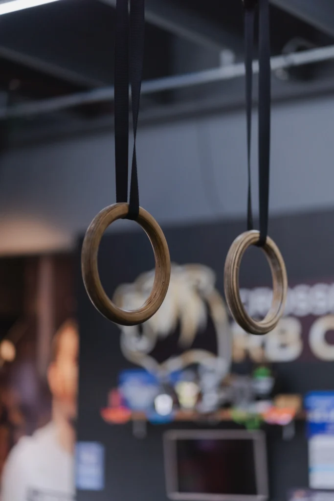 Wooden gymnastic rings hanging in a training gym