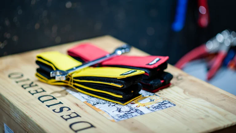 Folded wrist wraps with hook-and-loop closures in yellow and red