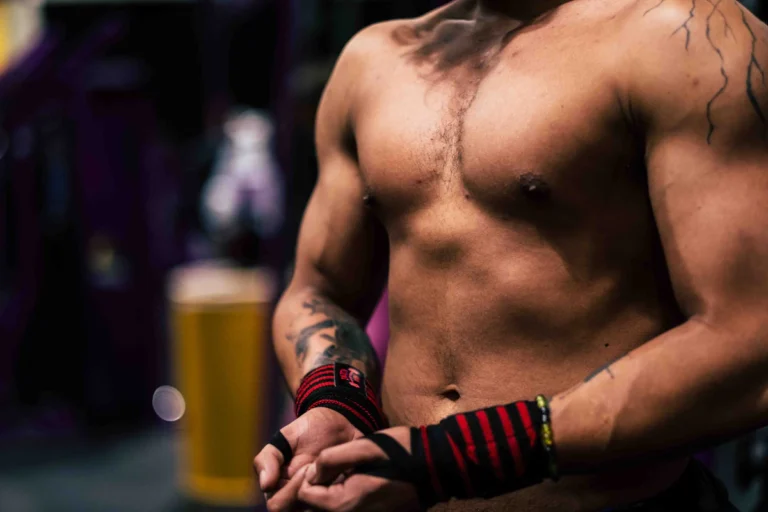 Lifter wearing red and black wrist wraps